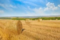 Straw bales on wheat field and blue sky. Royalty Free Stock Photo