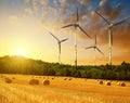 Straw bales with wind turbines on farmland