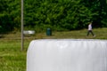 Straw ball in ensilage, man in background