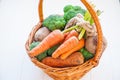 Straw Basket with garden Vegetables - fresh carrots, beets, broccoli, onions on the white wooden background. Farm Harvest. Food or Royalty Free Stock Photo