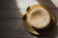 Straw beach hat with brims for sun protection on wooden boards.