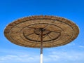 straw beach umbrella against the background a clear blue sky close up Royalty Free Stock Photo