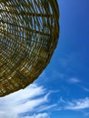 Straw beach umbrella against the blue sky Royalty Free Stock Photo