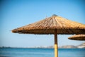 Straw Beach Umbrella by the Sea Royalty Free Stock Photo