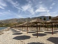 straw beach umbrellas in rows on the beach