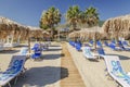 Straw beach umbrellas and sun chairs on a sandy beach on the east coast of Zakynthos island, Greece Royalty Free Stock Photo