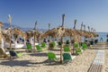 Straw beach umbrellas and sun chairs on a sandy beach on the east coast of Zakynthos island, Greece Royalty Free Stock Photo