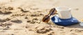 straw blue hat glasses on sand tropical beach. Vocation concept. Copy past