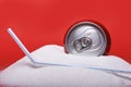 Straw and cola refreshing drink can sitting in pure white sugar mountain Royalty Free Stock Photo