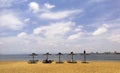 Straw covered umbrella on the beach with turquoise water in the background Royalty Free Stock Photo