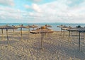 Straw covered umbrella on the beach with turquoise water in the background Royalty Free Stock Photo