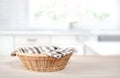 Straw empty basket on kitchen table.Food advertisement display