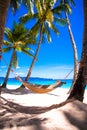 Straw hammock on tropical white sandy beach Royalty Free Stock Photo