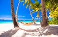 Straw hammock on tropical white sandy beach Royalty Free Stock Photo