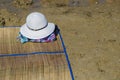 Straw hat, bag, sun glasses and flip flops on a tropical beach. Royalty Free Stock Photo