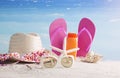Straw Hat, Bag, Sun Glasses And Flip Flops On A Tropical Beach