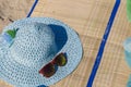 Straw hat, bag, sun glasses and flip flops on a tropical beach. Royalty Free Stock Photo