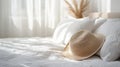 Straw Hat On Bed In Bright Room With White Linen Sheets Royalty Free Stock Photo