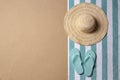 Straw hat, flip flops and space for text on beach sand, top view. Summer vacation Royalty Free Stock Photo