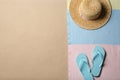 Straw hat, flip flops and space for text on beach sand, top view. Summer vacation Royalty Free Stock Photo