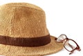 Straw hat with glasses on white background