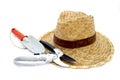 Straw hat and hand trowel and pruning shear on white Royalty Free Stock Photo