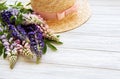 Straw hat and lupine flowers Royalty Free Stock Photo