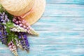 Straw hat and lupine flowers Royalty Free Stock Photo