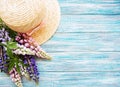 Straw hat and lupine flowers Royalty Free Stock Photo