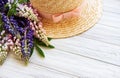 Straw hat and lupine flowers Royalty Free Stock Photo