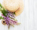 Straw hat and lupine flowers Royalty Free Stock Photo