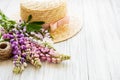 Straw hat and lupine flowers Royalty Free Stock Photo