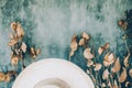 Natural elements create a soothing atmosphere with dried leaves and a straw hat on a blue background Royalty Free Stock Photo