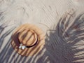 Straw hat on sand, sun protection concept. Royalty Free Stock Photo