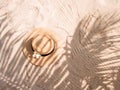 Straw hat on sand, sun protection concept. Royalty Free Stock Photo