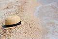 Straw hat on sand, sun protection concept. Women`s beach accessories or summer outfit Royalty Free Stock Photo