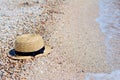 Straw hat on sand, sun protection concept. Women`s beach accessories or summer outfit Royalty Free Stock Photo