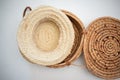 Straw hat sitting on top of handmade woven basket