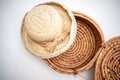 Straw hat sitting on top of handmade woven basket