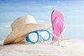 Straw hat, snorkel mask and flip flops on a tropical beach Royalty Free Stock Photo