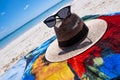 Straw hat, sun glasses and flip flops on a tropical beach Royalty Free Stock Photo