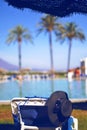 Straw hat, sun glasses on the lounger, near pool.