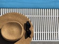 Straw hat and sunglasses along the poolside. Copy space. Summer concept. Top view. Vacation concept Royalty Free Stock Photo