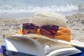 Straw hat sunglasses and a book on the beach Royalty Free Stock Photo