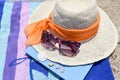 Straw hat, sunglasses and a book on the beach Royalty Free Stock Photo