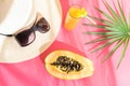 Straw Hat Sunglasses Tall Glass with Tropical Fruit Juice Papaya Palm Leaf on Fuchsia Background. Sunlight Leaks. Summer Vacation