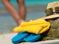 Straw hat, towel beach sun glasses and flip flops on a tropical Royalty Free Stock Photo