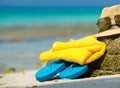 Straw hat, towel beach sun glasses and flip flops on tropical Royalty Free Stock Photo