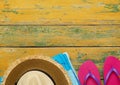 Straw hat, towel and slippers on wood Royalty Free Stock Photo