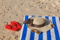 Straw hat, towel, sunglasses and flip flops Royalty Free Stock Photo